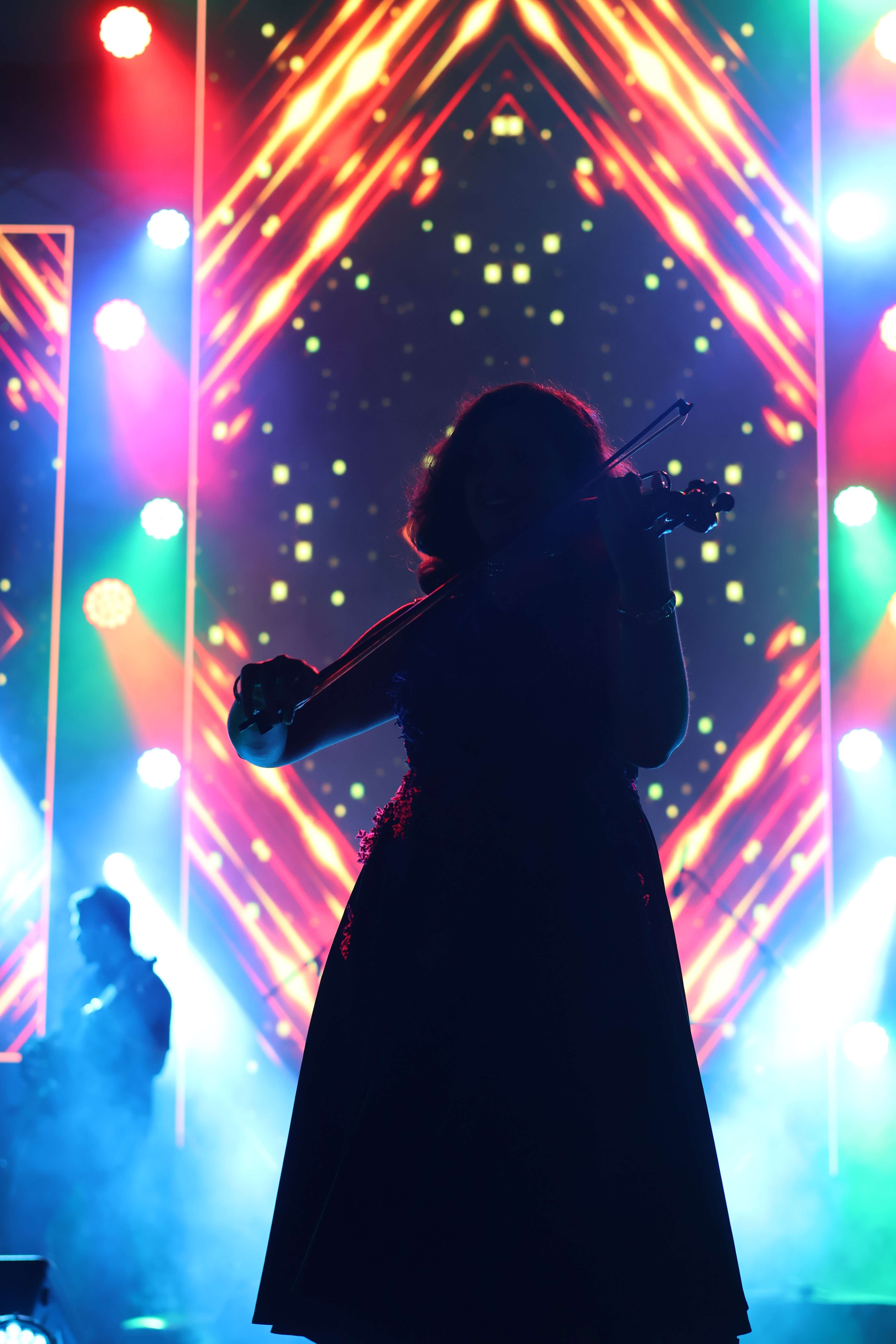 Silhouette against colorful LED lights