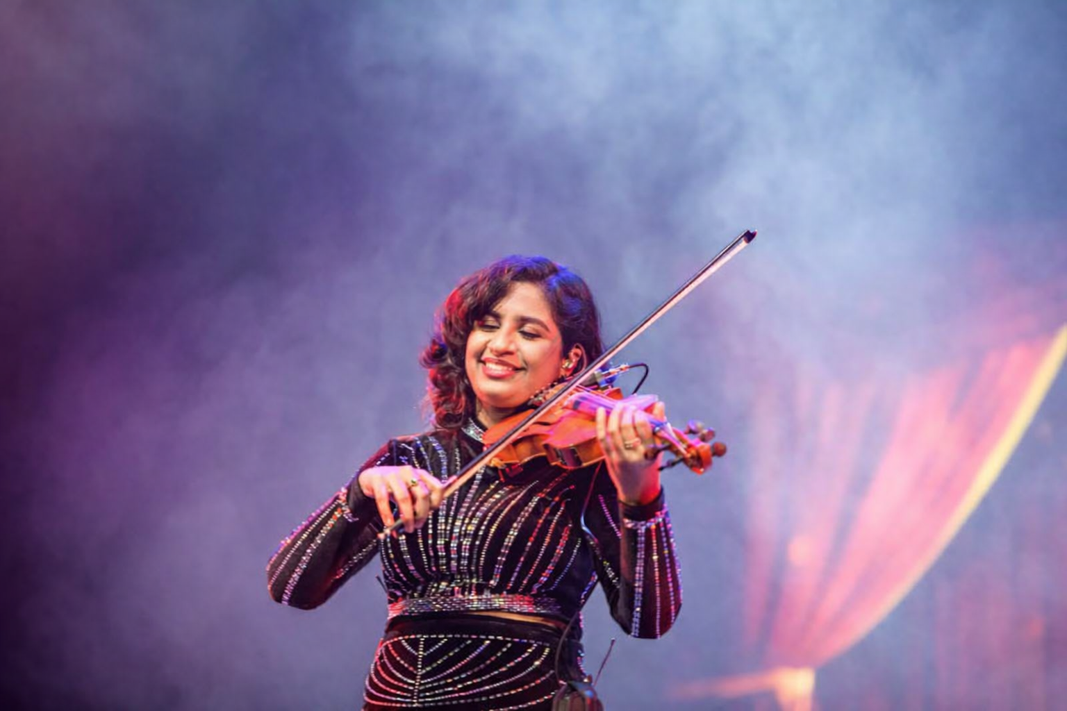 Playing violin in sparkling dress
